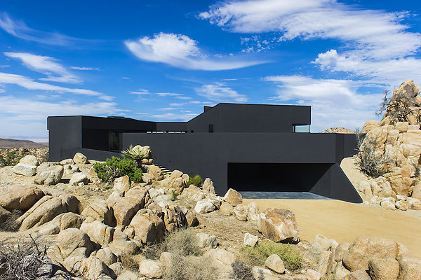 The-Black-Desert-House-by-Marc-Atlan-with-Oller-Pejic-opt - The Black Desert House is a professional location rental available for fashion and editorial photo shoots, advertising campaigns, television commercials, movies and films. Its contemporary architecture and modern design, combined with views of the scenic landscape of Joshua Tree and its private, secluded environment make it the perfect filming location. Only 2 hours from Los Angeles and 30 minutes from Palm Springs, this exclusive private residence can be rented for shooting motion pictures, television productions or background scenery.